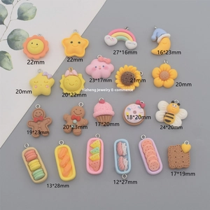 Detailed flat lay of colorful resin charms including rainbow, sun, and sweet dessert shapes
