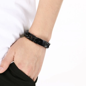 Detail of 16mm thick black stainless steel curb chain bracelet worn on male wrist