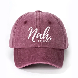 Washed burgundy cotton baseball cap featuring white 'Nah. I'M GOOD.' slogan on the front