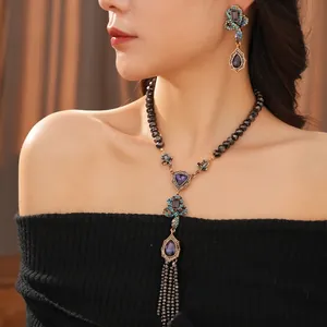 Vintage boho snake-style jewelry set with deep purple gems and emerald rhinestones