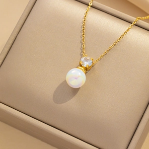 Elegant gold titanium necklace with iridescent pearl and zircon pendant in beige gift box