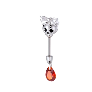 Skull earring with bow and orange water-drop gemstone pendant in polished silver finish