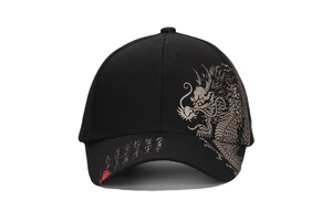 Detail of golden dragon pattern and artistic calligraphy on black cotton baseball cap