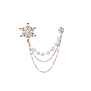 Elegant gold snowflake pearl brooch with triple tassel chains and chic jewelry details