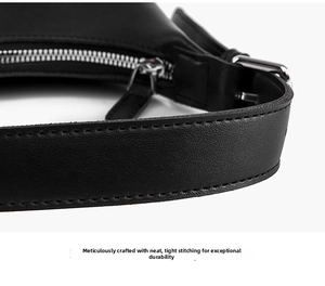 Close-up of black leather underarm bag featuring precise stitching and silver metal buckle