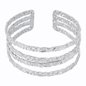 Detail of silver multi-layer open cuff bracelet with handcrafted hammered metal finish