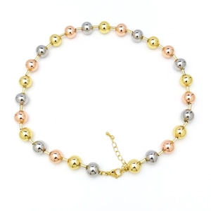 Macro shot of 18k gold-plated tri-color beads necklace with lobster clasp and chain