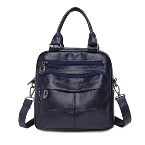 Dark blue soft leather convertible backpack with multiple zippers and wide strap