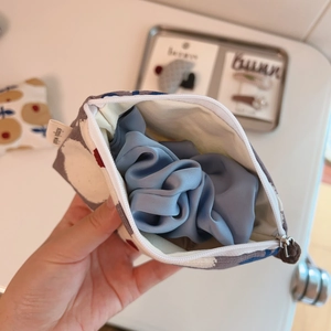 Japanese style floral canvas pouch with a zipper closure and blue satin hair scrunchie