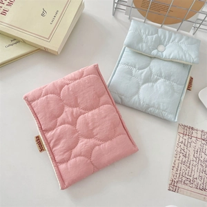 Close-up of quilted cloud texture and snap button on pink and blue sanitary storage bags