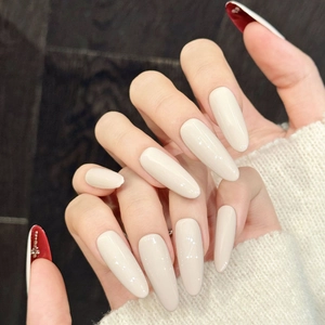 Long oval cream white press-on nails with shiny glitter and hidden red underside rhinestones
