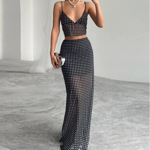 Women's two-piece set featuring black mesh polka dot crop top and high-waisted maxi skirt