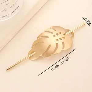 Golden brushed monstera leaf hair pin with hollow-out metal design for elegant hair styling