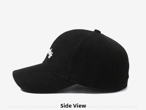 Close-up of black corduroy baseball cap featuring white side embroidery detail