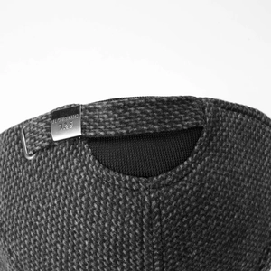 Detail view of winter baseball cap with silver metal buckle and wool texture