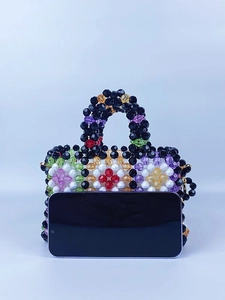 Handmade woven beaded handbag with colorful flower patterns and pearl accents