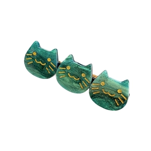 Green glitter acetate cat hair clips set with gold-lined cat face features and metal duckbill