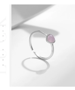 Close-up of S925 sterling silver ring with a pink heart cat-eye stone in a detail macro shot