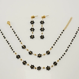 Detail view of bohemian gold flower jewelry set with black crystal beads for women