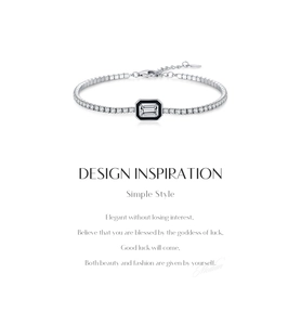 Macro shot of silver tennis bracelet with emerald-cut stone and black enamel frame