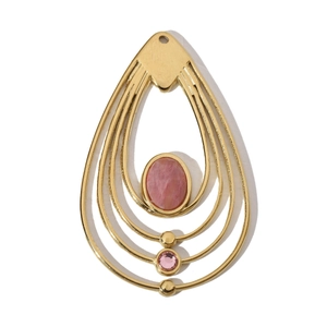 Detailed view of teardrop gold pendant with large pink gemstone and metallic accents