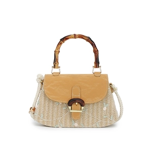 Retro straw handbag with floral embroidery and bamboo handle on white background