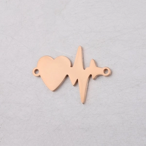 Macro shot of rose gold heartbeat connector with heart charm for DIY jewelry making
