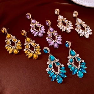 Detail of hollow waterdrop earrings set with colorful rhinestones in four elegant colors