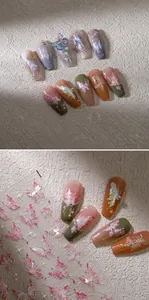 Detail of 3D butterfly nail stickers and press-on nails with pearls and glitter