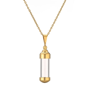 Close-up of golden cylinder perfume bottle pendant with transparent glass and metal cap