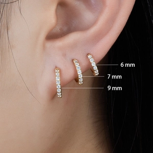 Three sizes of 925 sterling silver huggie earrings with gold finish and zircon stones
