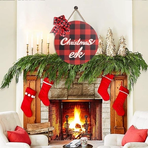 Detail of 28cm Christmas wooden door sign with red plaid pattern and bow on a fireplace