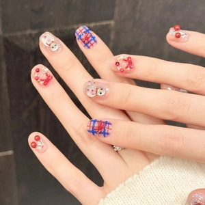 Winter cherry snowman press-on nails with red bow and plaid patterns on silver glitter