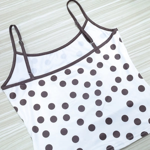 Detailed view of adjustable straps and polka dot print on a summer crop top