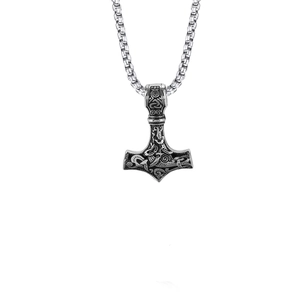 Close-up of Mjolnir pendant with intricate Norse knotwork on a stainless steel chain