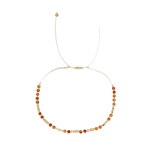 Handmade bohemian beaded bracelet with orange stones and adjustable gold spacers