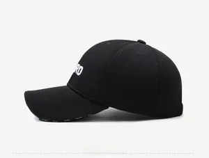 Close-up of white letter RD embroidery on a black structured cotton baseball cap