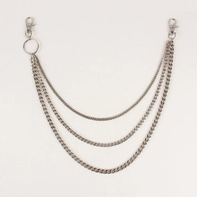Close-up of triple-layered silver curb chains with lobster clasps for punk style