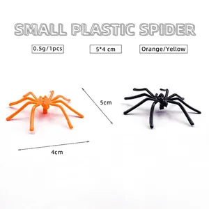 Realistic small plastic spiders in black and orange for Halloween decoration and pranks