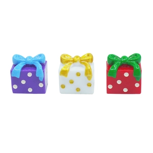 Three colorful resin Christmas gift boxes with bows for DIY festive table decorations