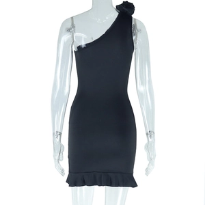 Detail of black one-shoulder dress with floral accent and elegant ruffled hemline