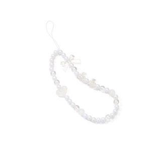 Detail of beaded phone strap with white pearls, transparent bow, and heart charm accessory