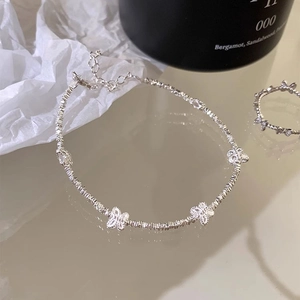 Elegant S925 sterling silver butterfly bracelet and ring set on minimalist background
