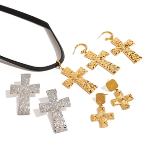 Detail showing vintage spiral texture on 18K gold and silver cross jewelry set