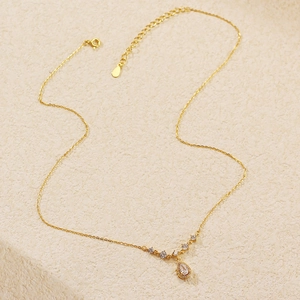 Detail of s925 silver necklace featuring a sparkling teardrop zircon pendant in gold finish