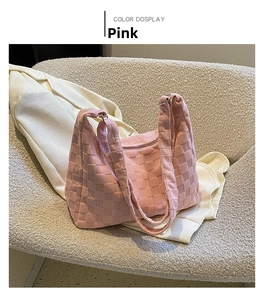Pink checkered tote bag styled on white suit jacket for an elegant lifestyle look