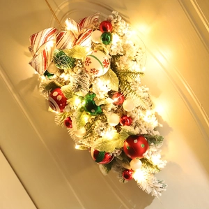 Detail of Christmas teardrop swag with flocked pine, painted baubles and LED lights