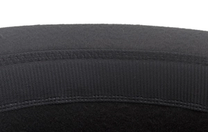Detailed macro view of black wool felt texture and elastic band stitching on a jazz hat
