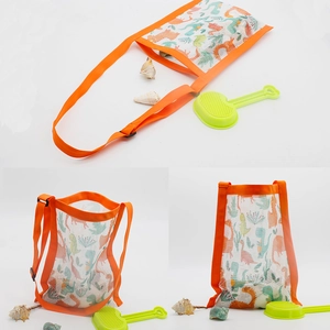 Detail of kids mesh beach bag with orange trim and colorful dinosaur prints