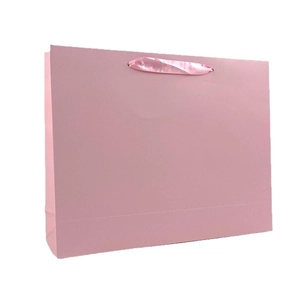 Elegant matte pink cardboard gift bag with matching ribbon handles for apparel packaging